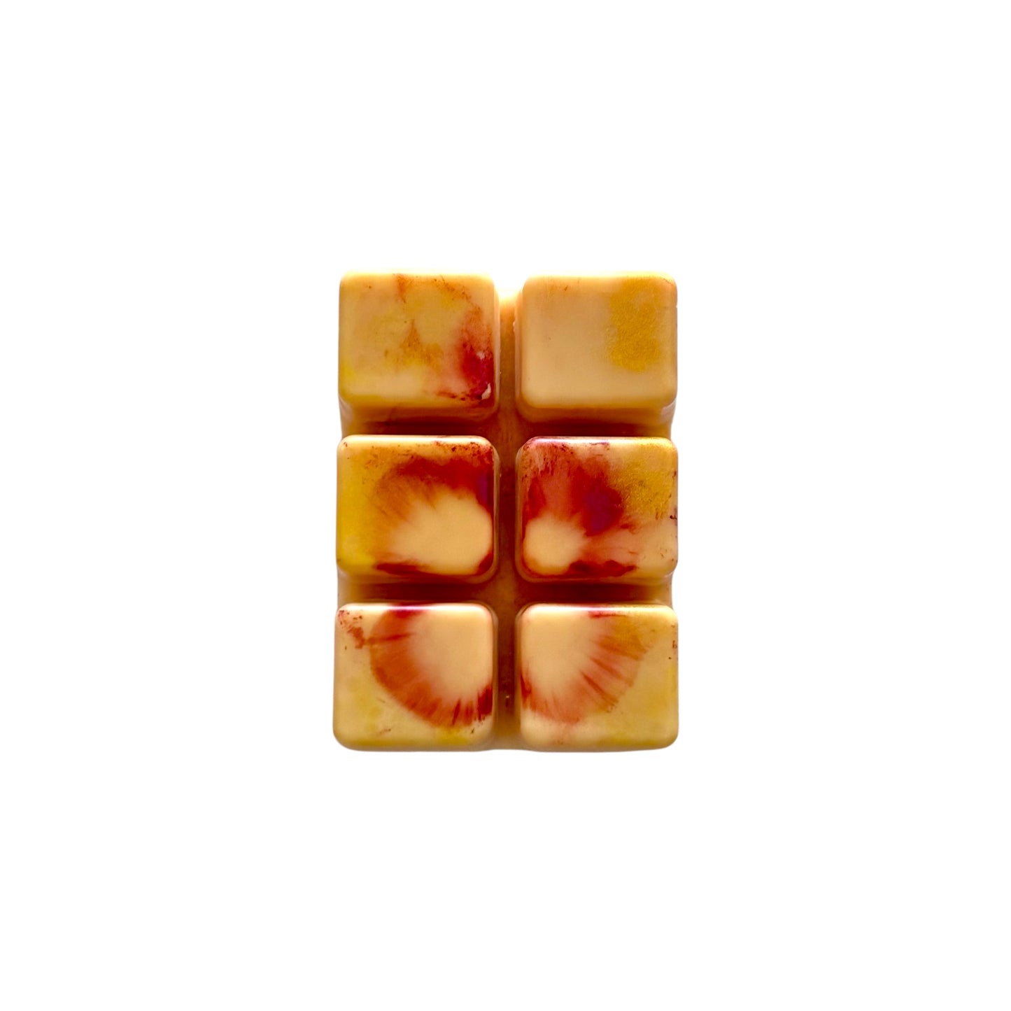 An orange colored wax melt with 6 cubed sections