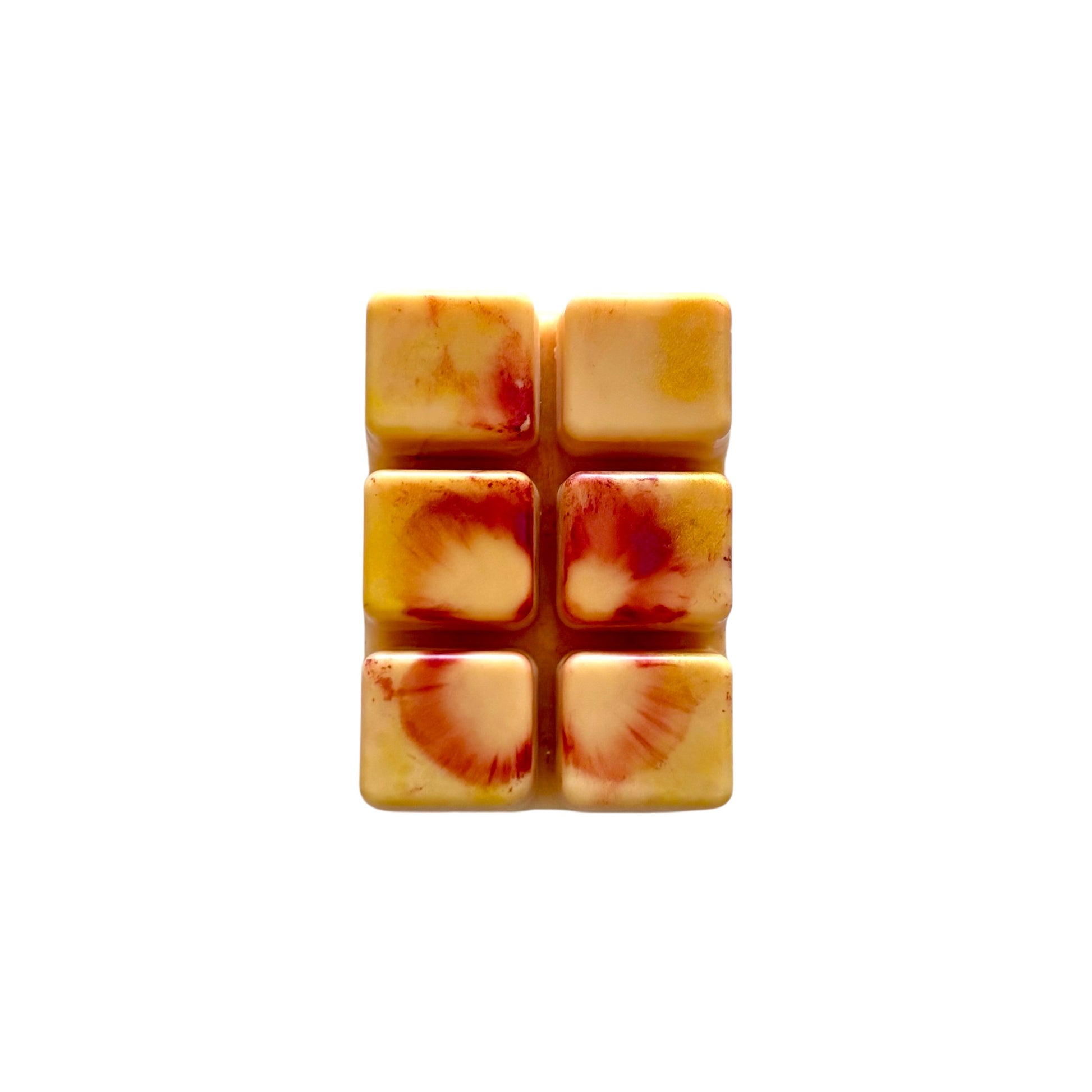 An orange colored wax melt with 6 cubed sections